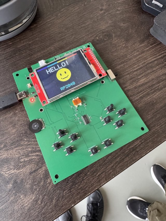Assembled Game Boy board with buttons and a powered display showing HELLO and RP2040