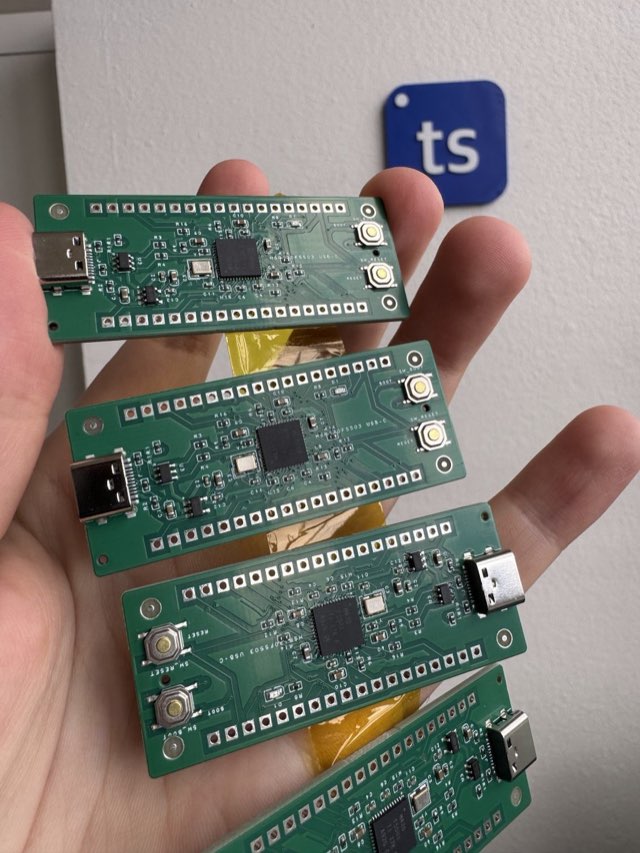 Four assembled MSP430F5503 Pico boards held in a hand